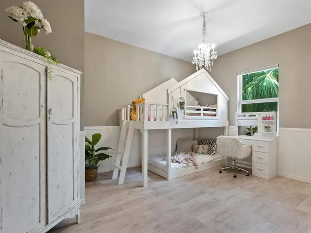 a bedroom with a bed and a desk