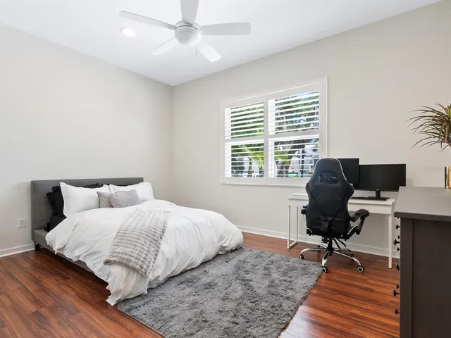 a living room with patio furniture and a floor to ceiling window