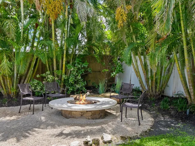 a living room with furniture large window and a fireplace