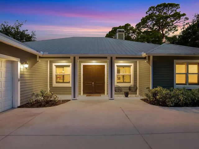 a kitchen with a sink a counter top space and living room filled with furniture