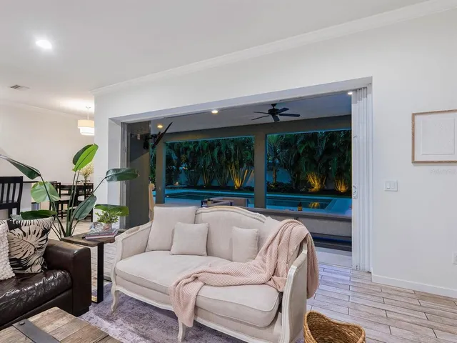 a view of the patio with dining table and chairs under an umbrella