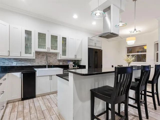 a view of a patio with table and chairs under an umbrella