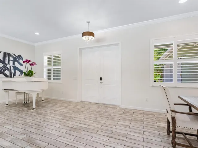 a living room with fireplace furniture and a large window