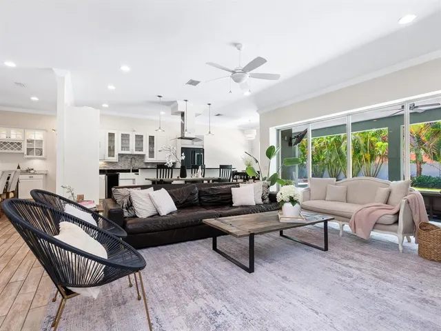 a living room with furniture large window and a fireplace