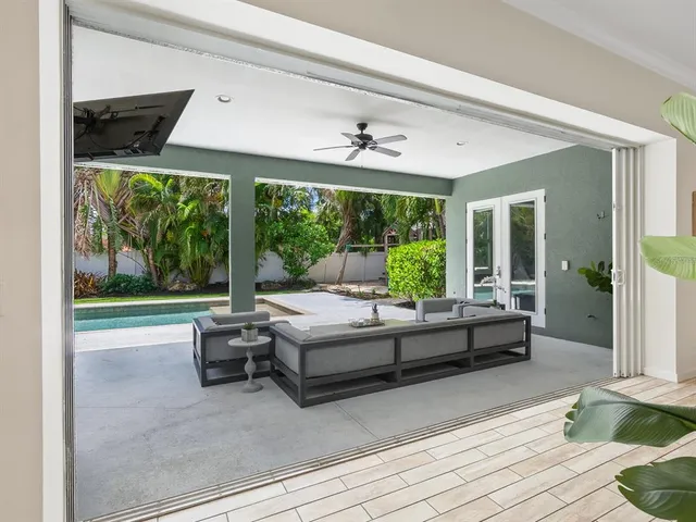 a living room with lots of furniture and kitchen view