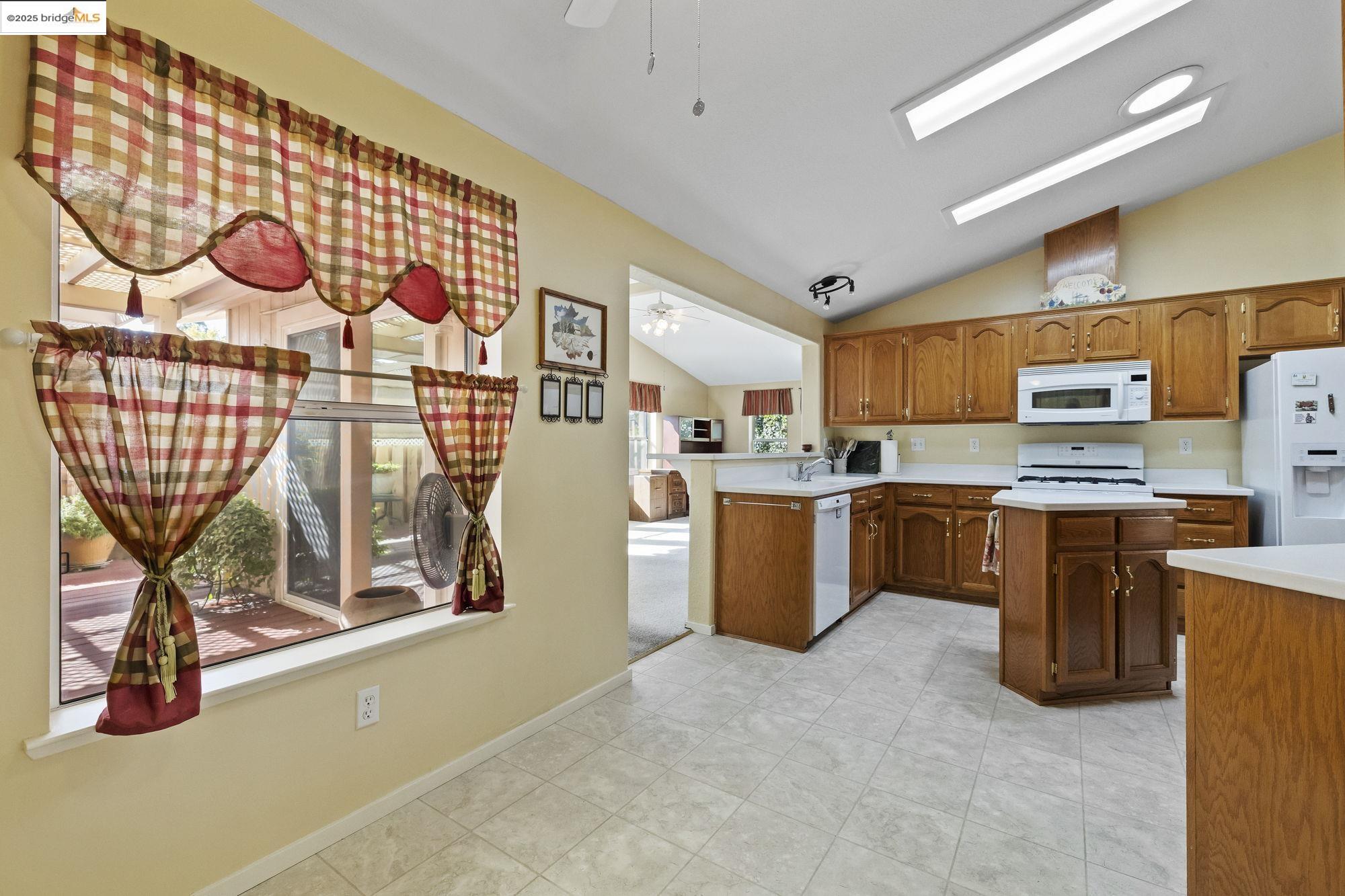 12700 Red Maple Circle, Unit 42 Sonora, CA 95370 - Photo 13 of 42 a view of a kitchen with fridge and workspace