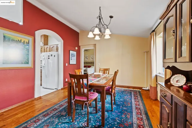 a view of a dining room with furniture and a chandelier