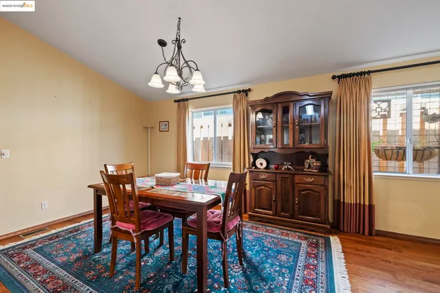 a view of a dining room with furniture wooden floor and chandelier