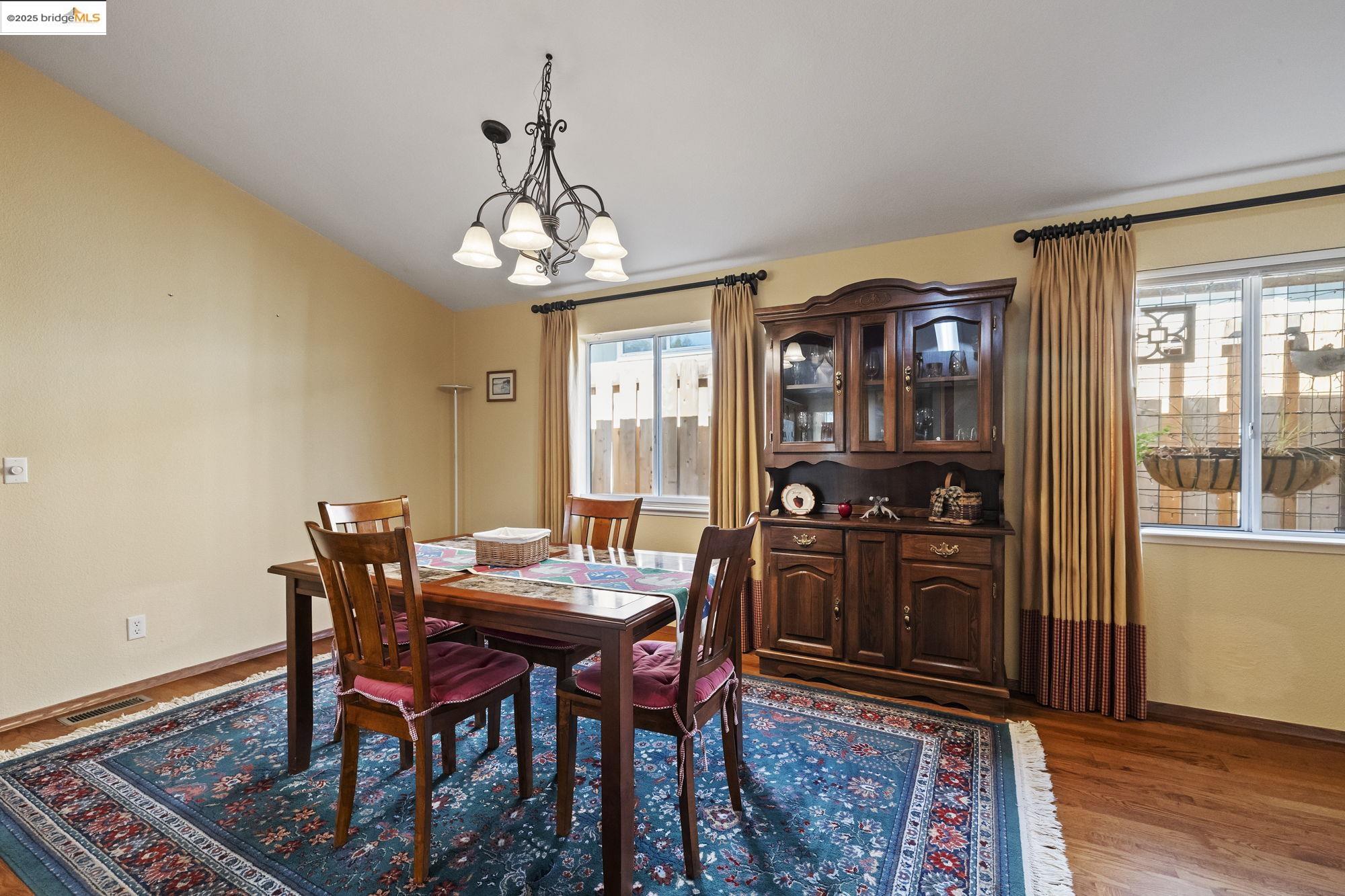 12700 Red Maple Circle, Unit 42 Sonora, CA 95370 - Photo 10 of 42 a view of a dining room with furniture wooden floor and chandelier