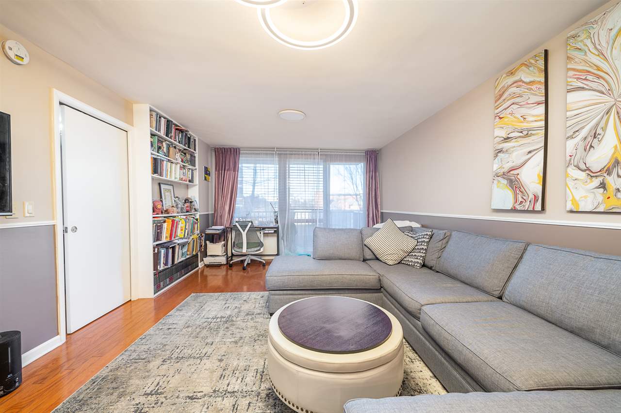 700 Grove Street, Unit 4V Jersey City, NJ 07310 - Photo 16 of 25 a living room with furniture and a large window