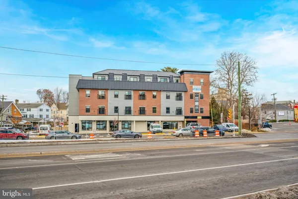 a front view of a building with parking