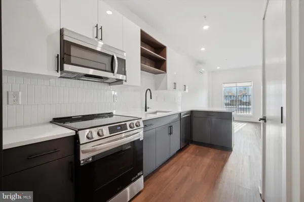 a kitchen with stainless steel appliances a refrigerator sink and microwave