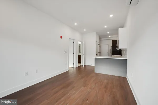 a view of a kitchen with a sink and refrigerator