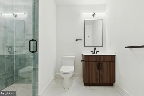 a bathroom with a toilet sink and shower