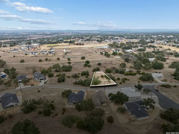 an aerial view of beach and residential houses with outdoor space
