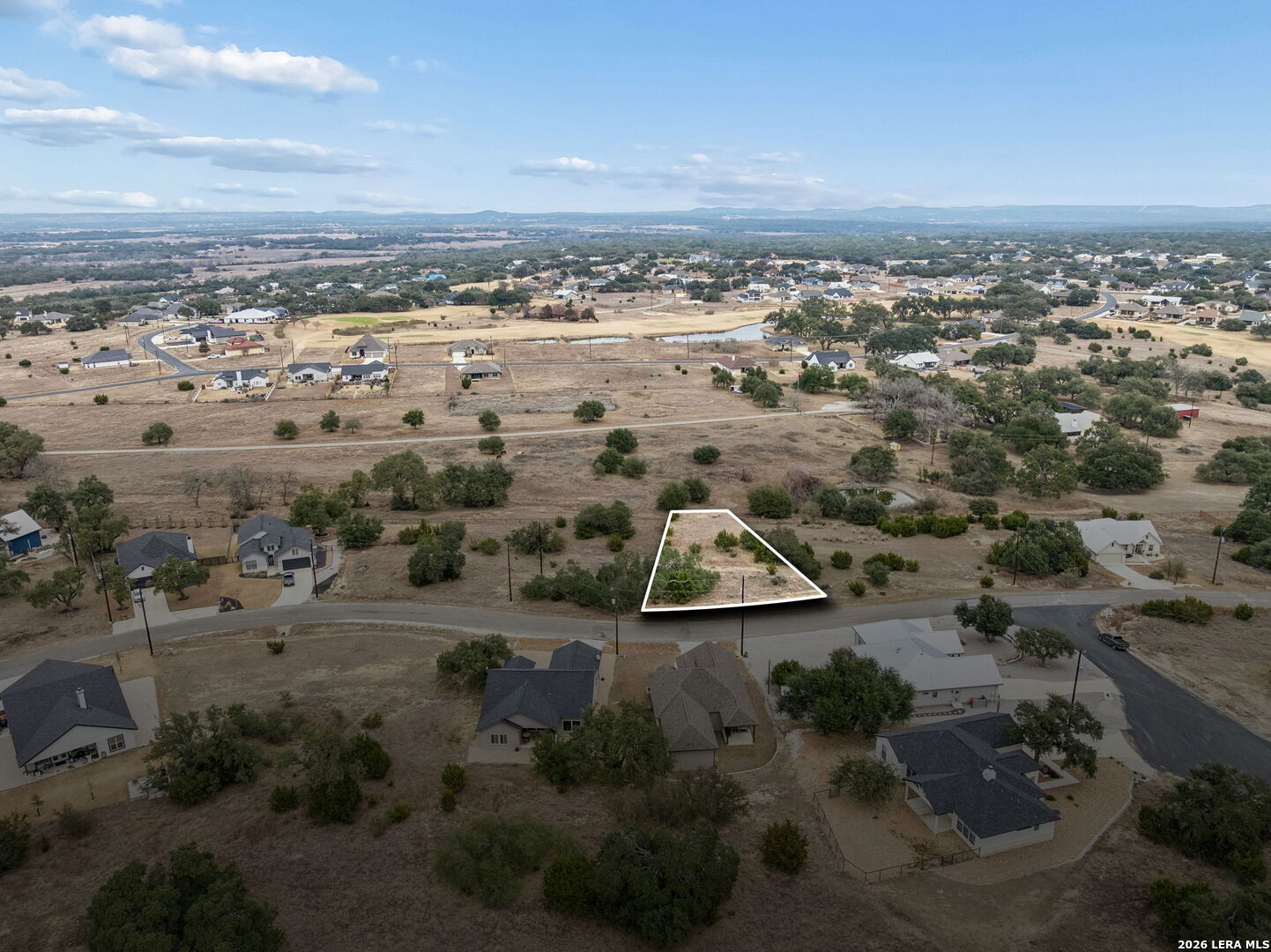 an aerial view of beach and residential houses with outdoor space