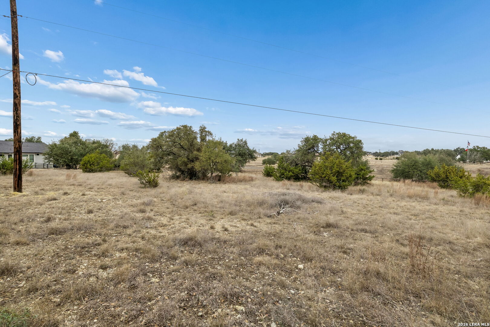132 West Pat Dolan Blanco, TX 78606 - Photo 11 of 43 a view of a dry yard with wooden fence