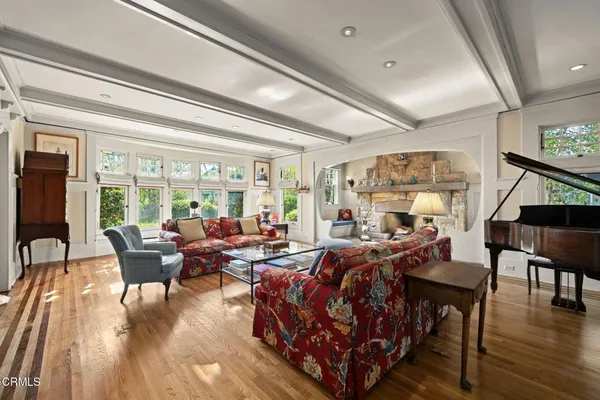 a living room with fireplace furniture and a large window
