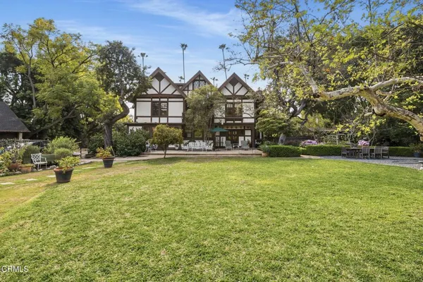 an aerial view of residential house with outdoor space and swimming pool