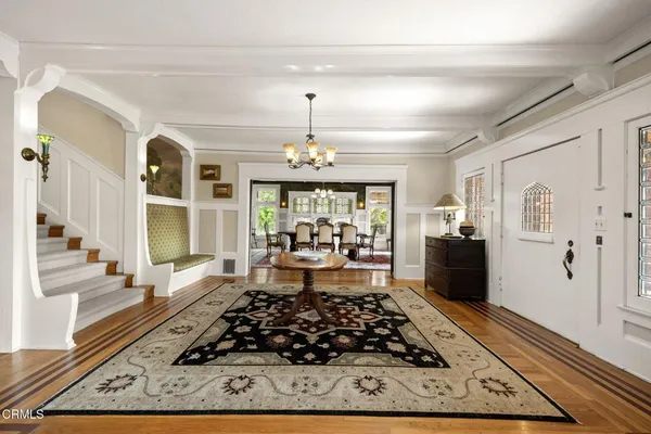 a living room with furniture fireplace and a large window