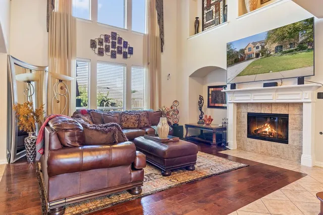 a living room with furniture a flat screen tv and a fireplace