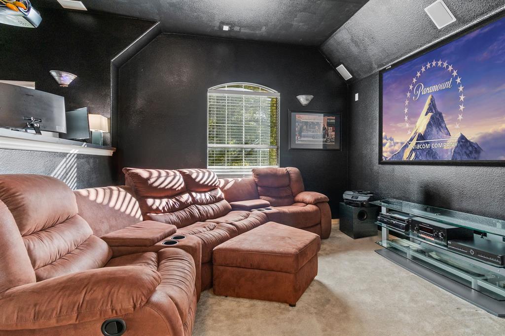 2228 Condor Street Grand Prairie, TX 75052 - Photo 19 of 33 a living room with furniture and a flat screen tv
