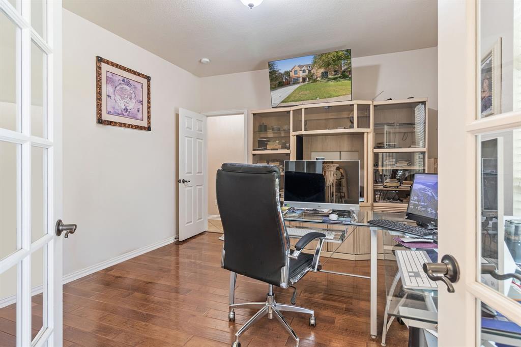 2228 Condor Street Grand Prairie, TX 75052 - Photo 22 of 33 a view of a workspace with furniture and wooden floor