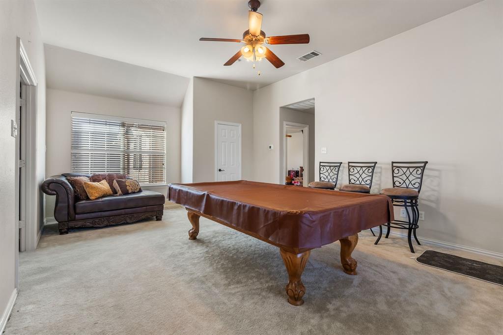 2228 Condor Street Grand Prairie, TX 75052 - Photo 24 of 33 a bedroom with furniture and a chandelier