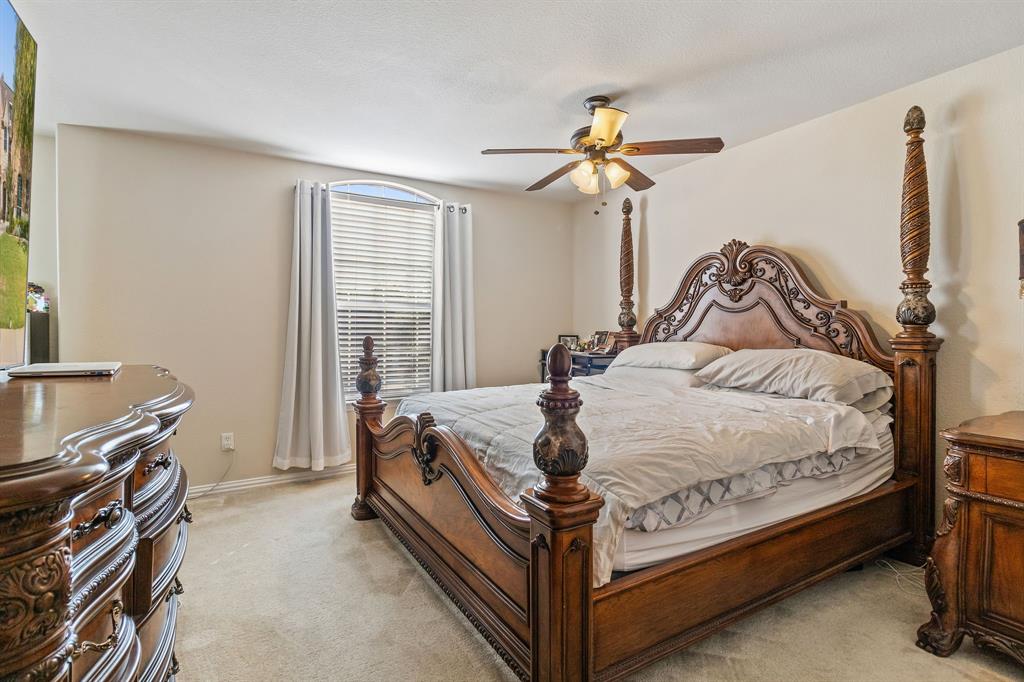 2228 Condor Street Grand Prairie, TX 75052 - Photo 28 of 33 a bedroom with a bed and a chandelier