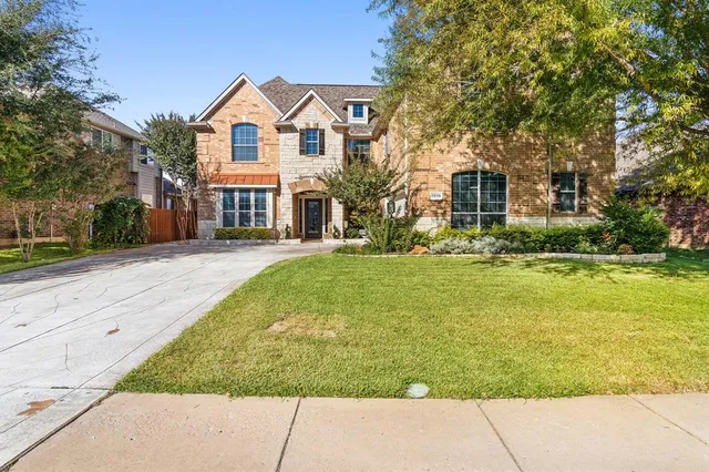 a front view of house with yard and green space