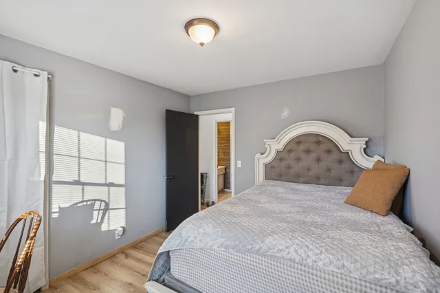 a bedroom with a bed and a window