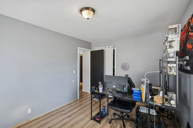 a view of a workspace with furniture and a window