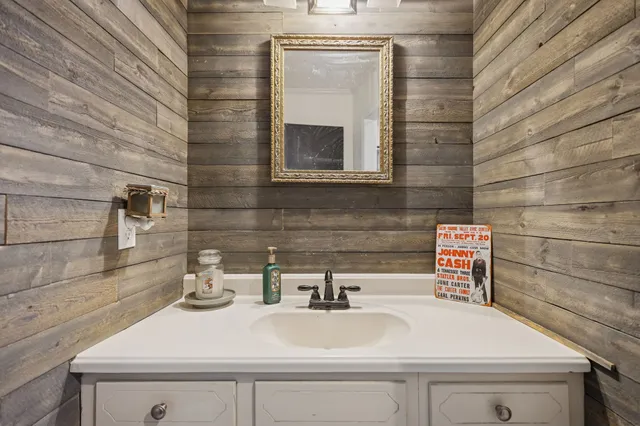 a bathroom with a sink a toilet and mirror