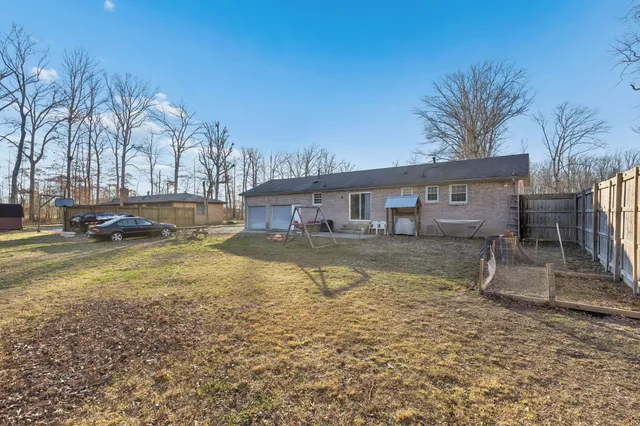 a view of a backyard with table and chairs under an umbrella
