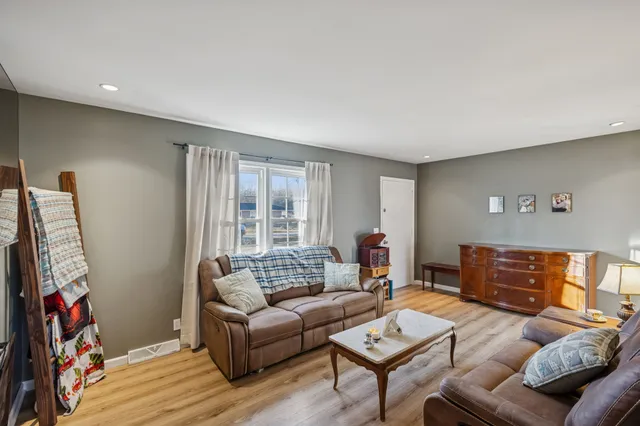 a view of a kitchen with fridge and workspace