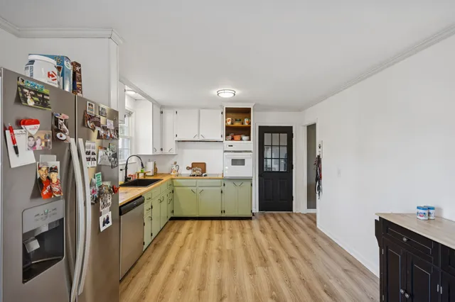 a view of a dining room with furniture and wooden floor