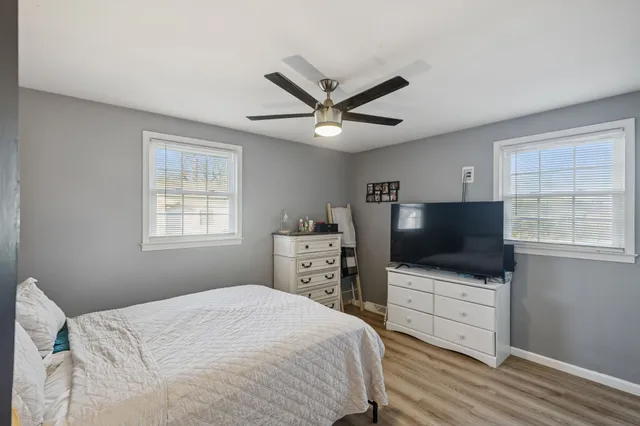 a bedroom with a large bed and a chandelier
