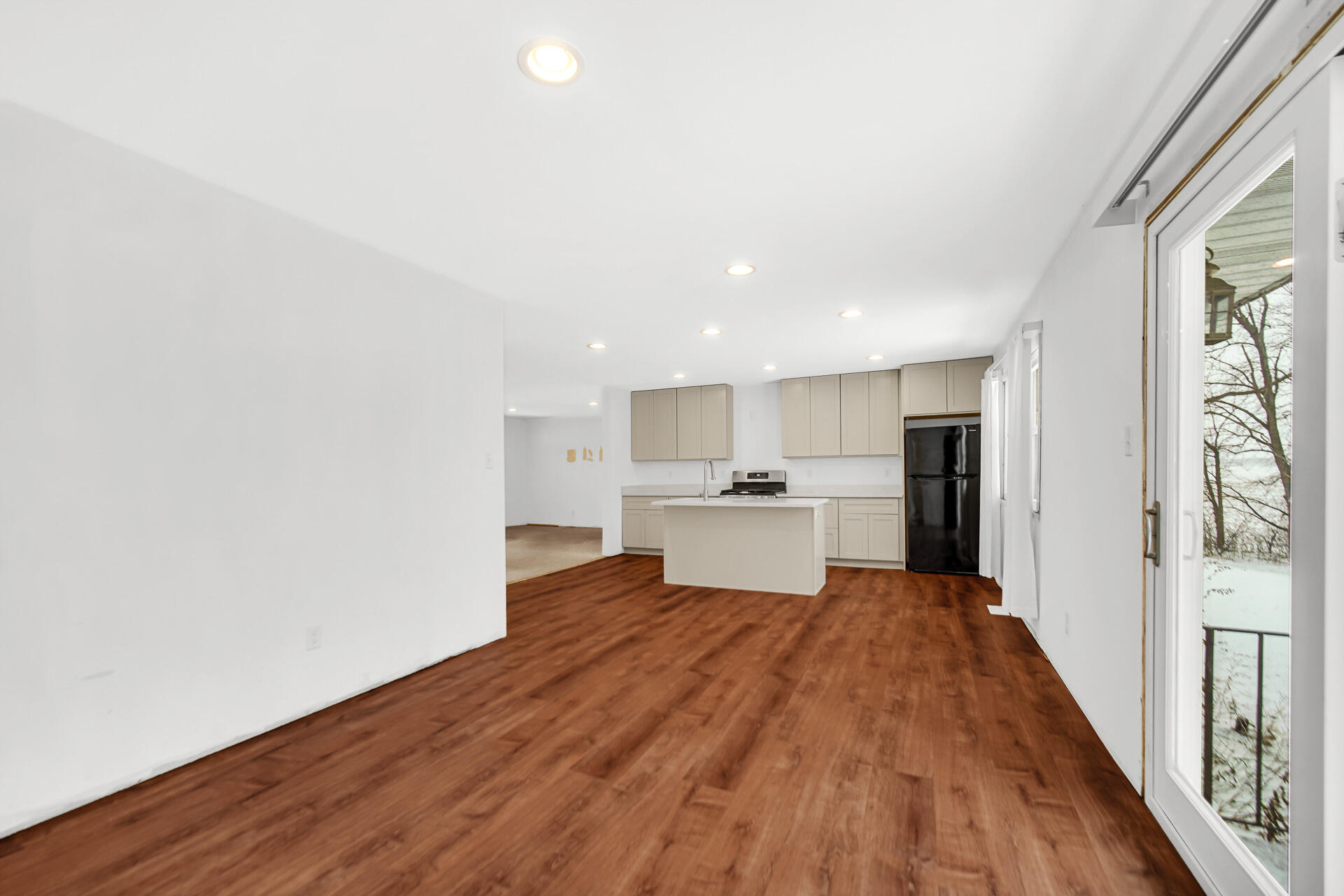7210 East 97th Avenue Crown Point, IN 46307 - Photo 3 of 25 a view of a kitchen with wooden floor and electronic appliances