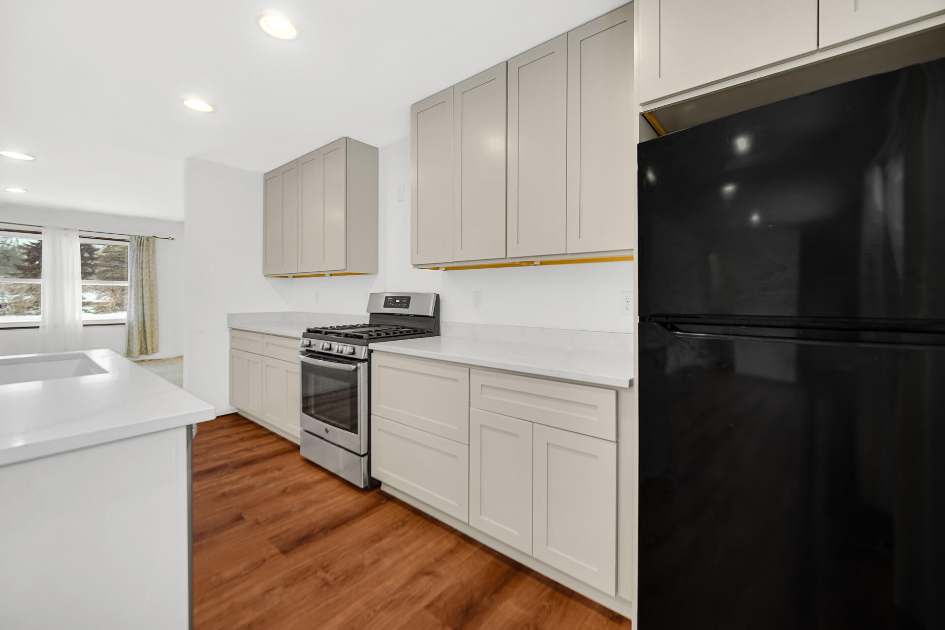 7210 East 97th Avenue Crown Point, IN 46307 - Photo 4 of 25 a kitchen with a refrigerator and white cabinets