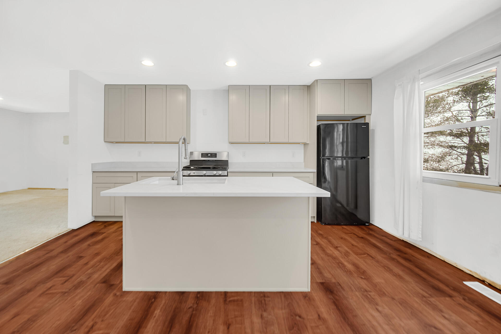 7210 East 97th Avenue Crown Point, IN 46307 - Photo 6 of 25 a kitchen with stainless steel appliances a refrigerator sink and wooden floor