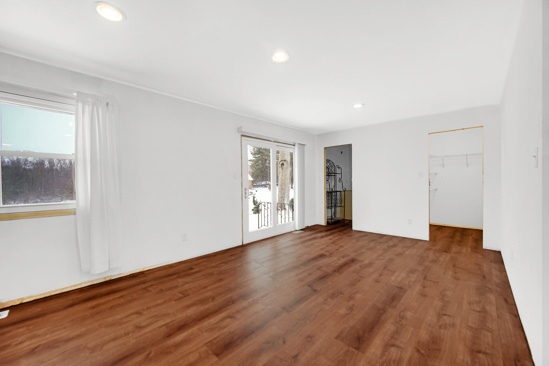 7210 East 97th Avenue Crown Point, IN 46307 - Photo 7 of 25 a view of an empty room with wooden floor and a window