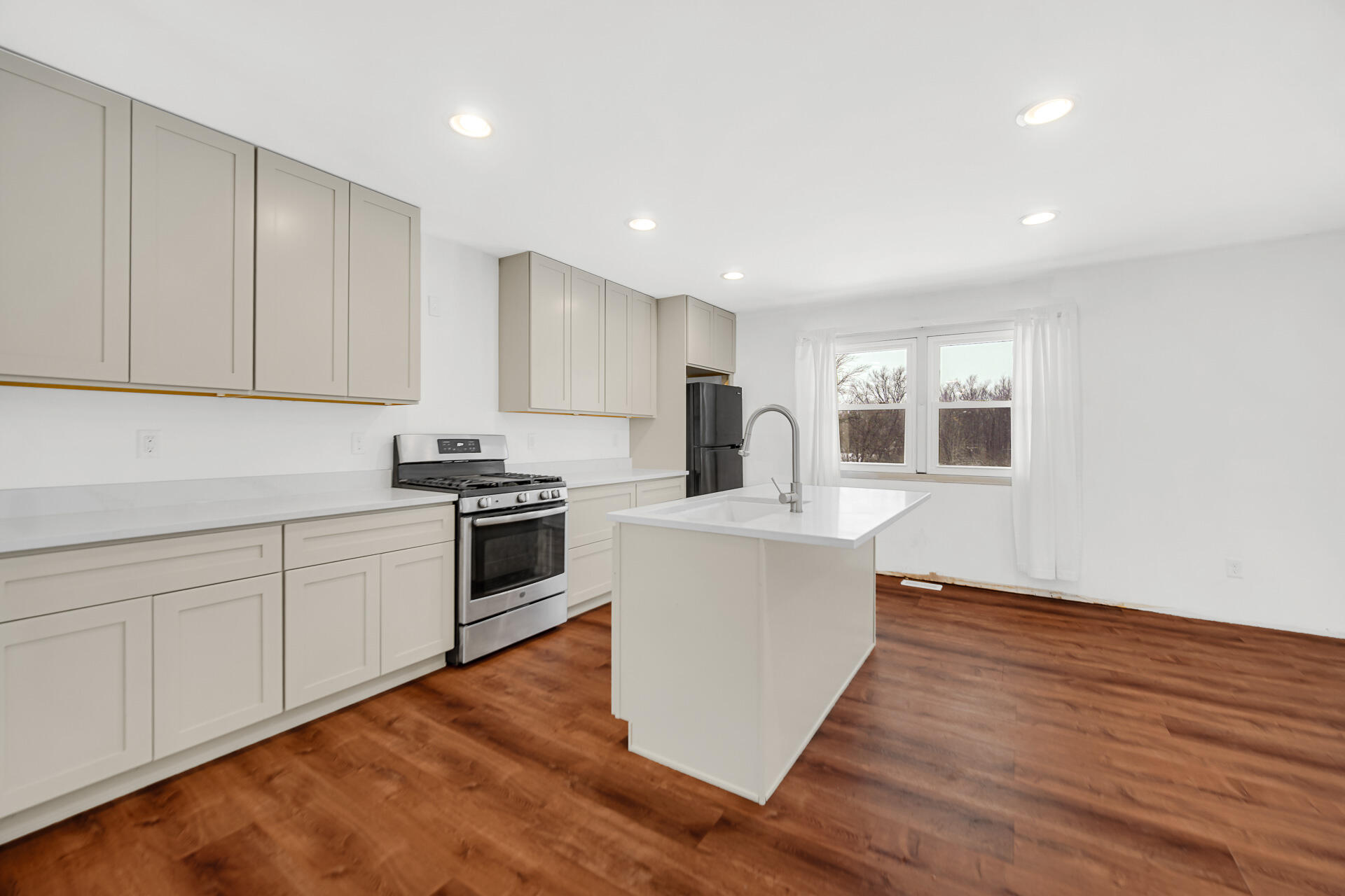 7210 East 97th Avenue Crown Point, IN 46307 - Photo 8 of 25 a kitchen with granite countertop white cabinets and white appliances