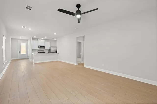 a view of a kitchen with a sink and a window