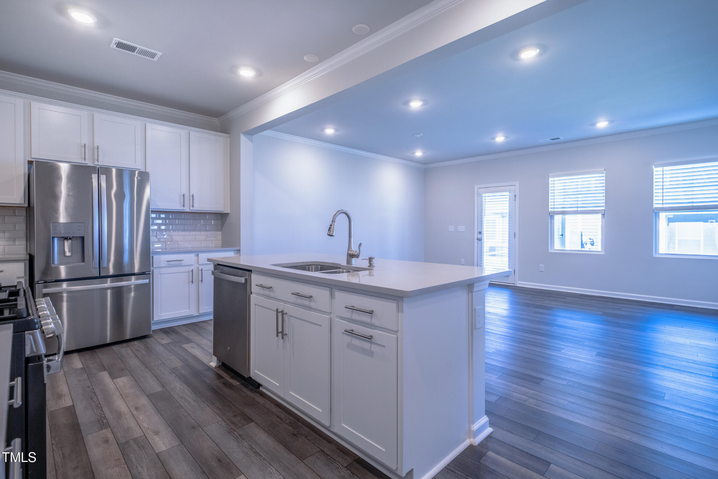 1726 Barrett Run Trail Apex, NC 27502 - Photo 18 of 50 a kitchen with kitchen island wooden floors appliances and cabinets