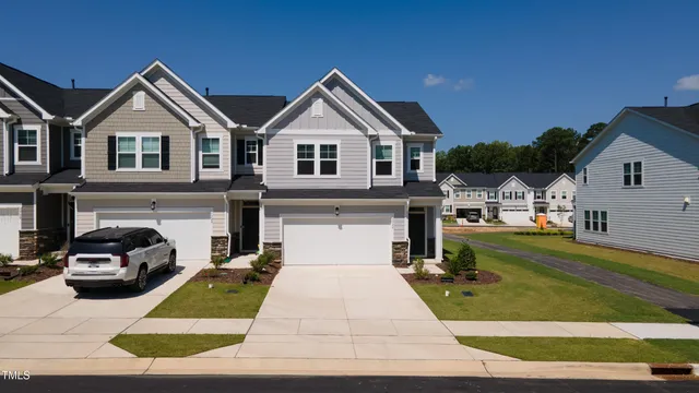 a view of a white house with a yard