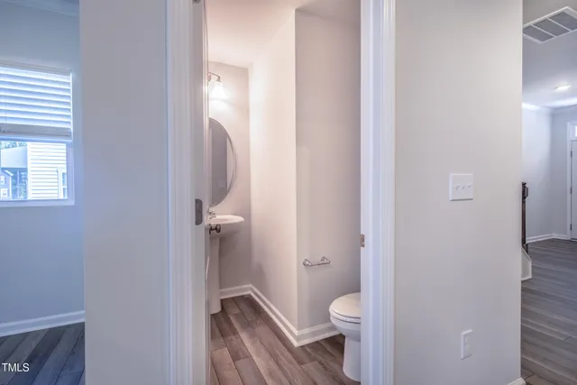 a bathroom with a granite countertop toilet and a sink
