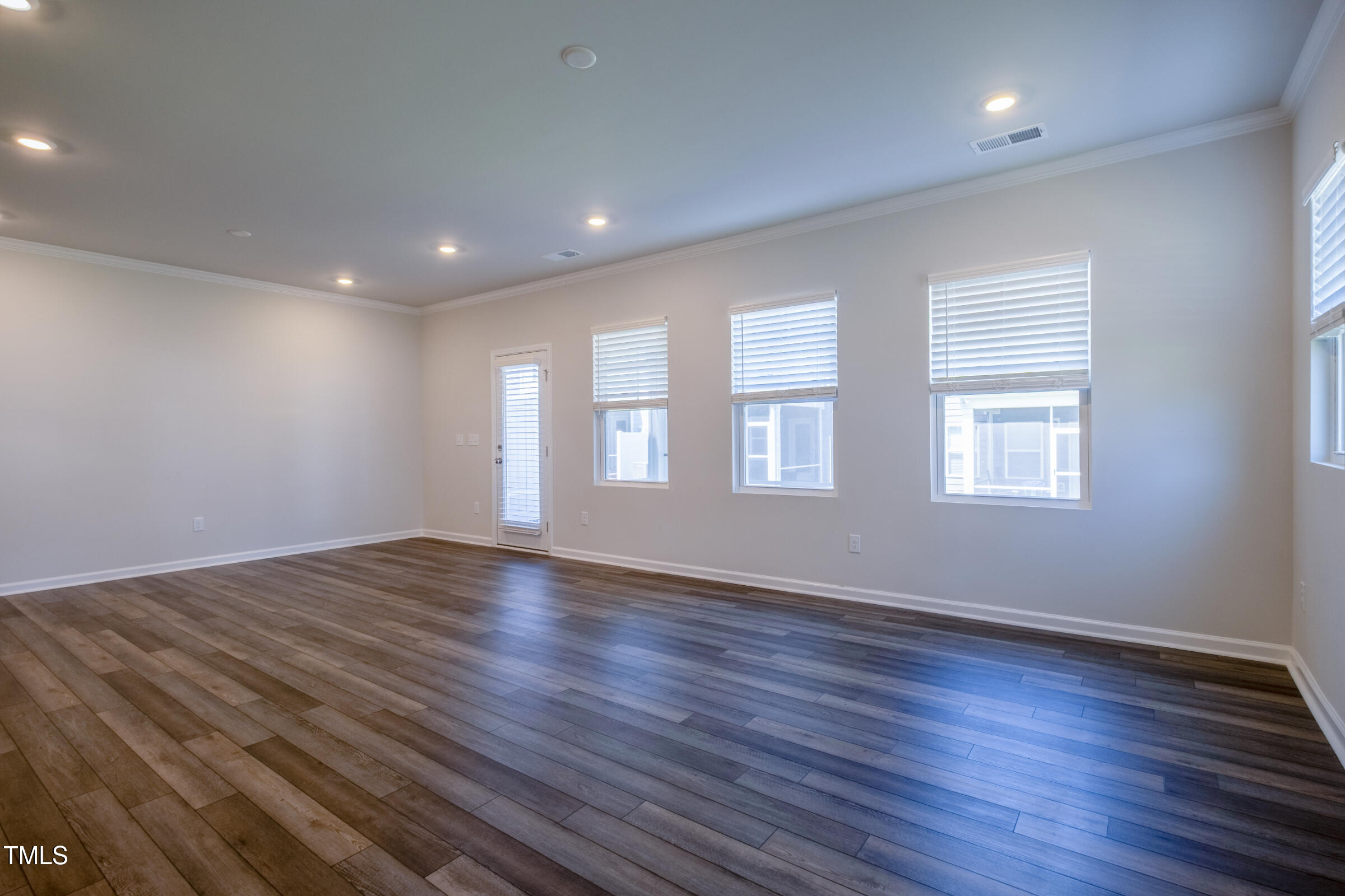 1726 Barrett Run Trail Apex, NC 27502 - Photo 22 of 50 a view of empty room with wooden floor and fan