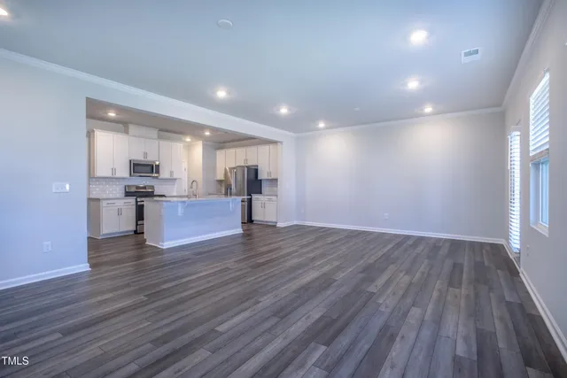 a view of kitchen with wooden floor and windows