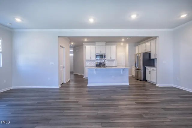 a view of kitchen and hall with wooden floor