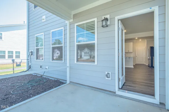 an empty room with entrance and windows